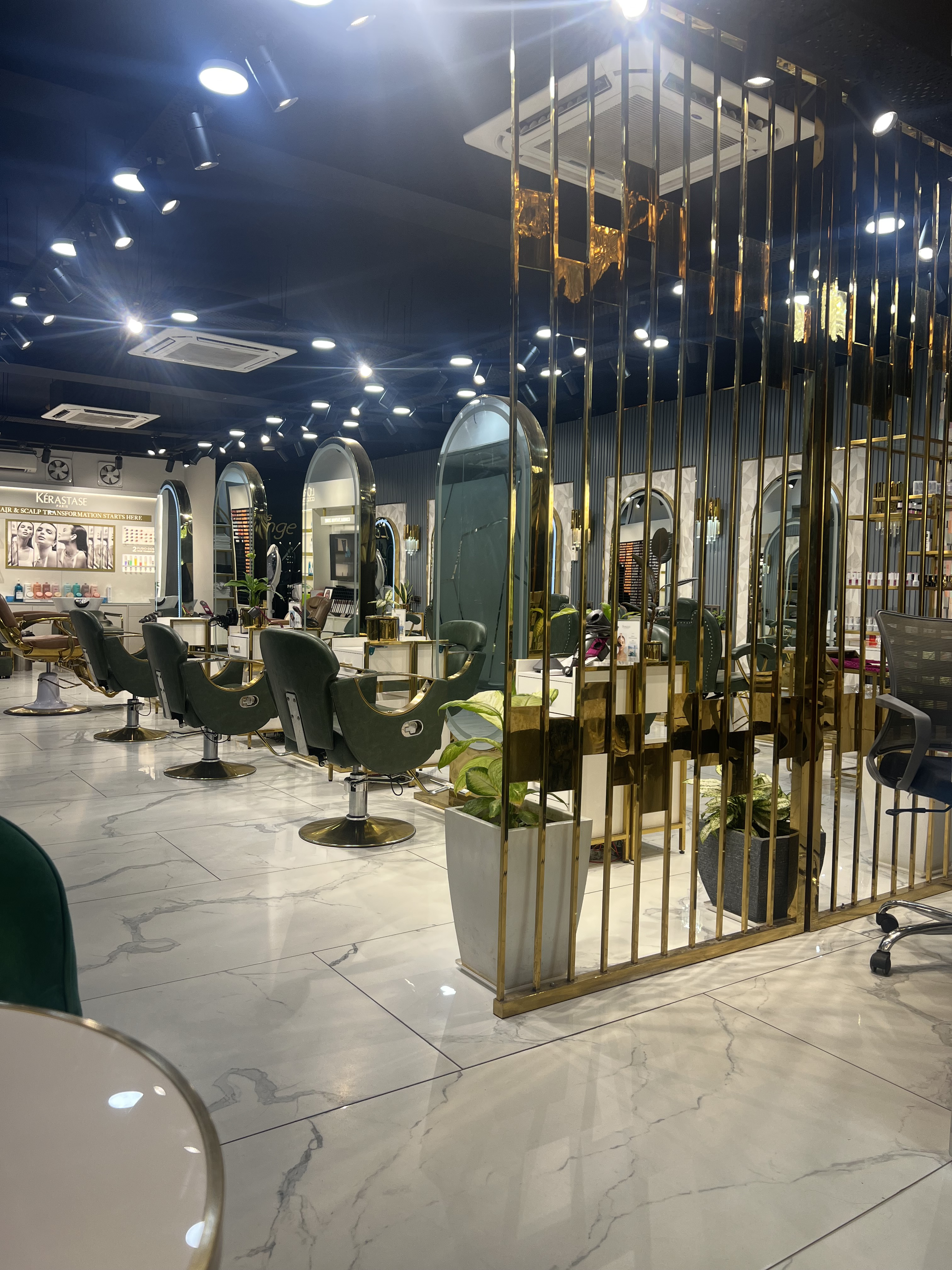 Brass screens, salon chairs and mirrors at Tress Lounge